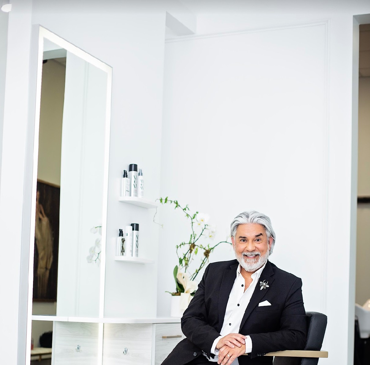 Quiet styling corner — mirror station, shelves, orchids